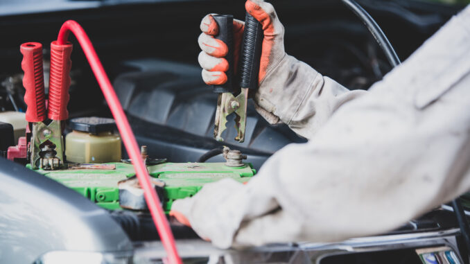 mechanic changing car battery